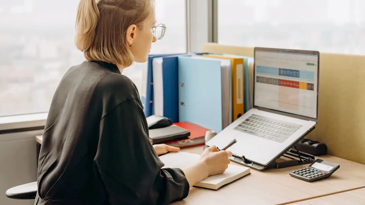 A spreadsheet open on a laptop in an office