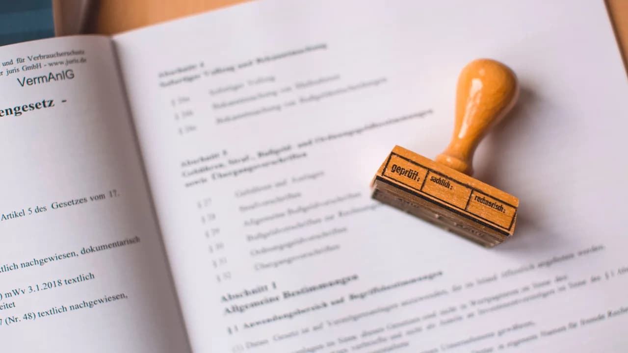 A wooden stamp resting on an open book