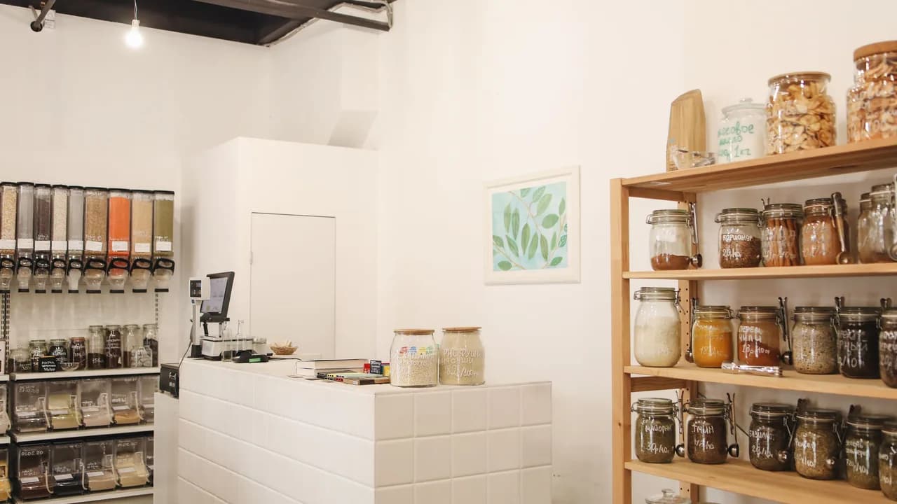 The interior of a small shop with wooden shelving