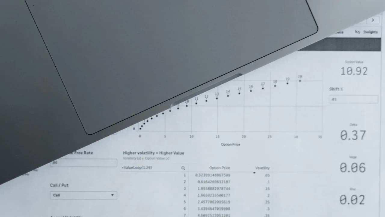 Printed data sheets and a laptop seen from above